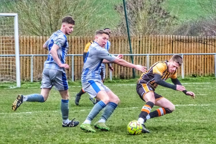 Holsworthy's Jay Thomas (centre) looks to win the ball at Tiger Way.