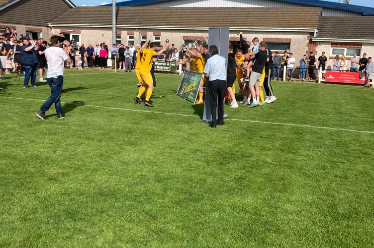 Torpoint Athletic celebrate winning the cup last season at Launceston AFC.