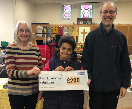 Jackie Tyler, representing the Launceston Community Market, presenting the cheque to Val and Mike Carpenter of Love Your Neighbour