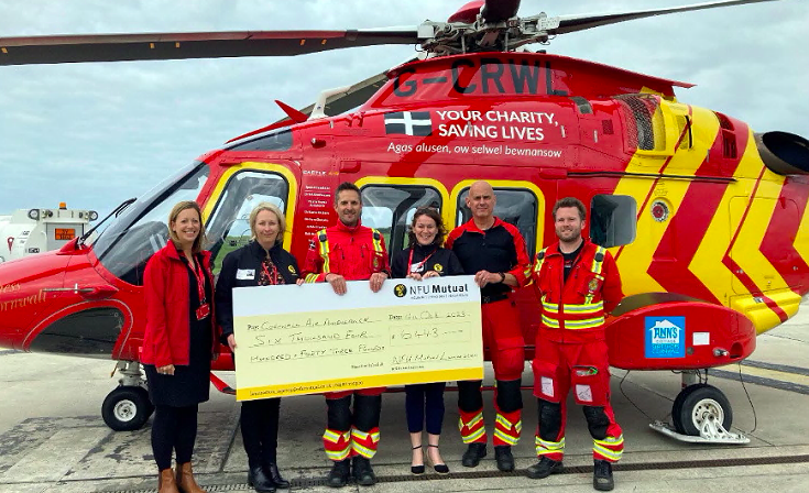 LEFT to right: Julia Jeffery, corporate fundraising officer at Cornwall Air Ambulance, Cheryl Valter agent
Launceston NFU Mutual and Rachel Sleep agent Launceston NFU Mutual with crew members from the Cornwall
Air Ambulance