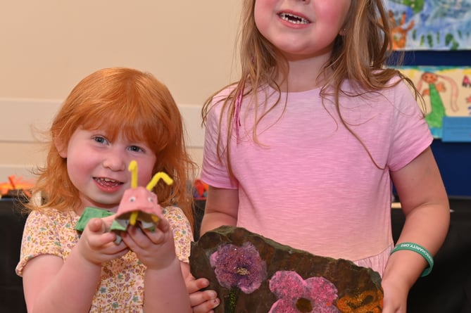 Lilly and Hollie Dodd with a Caterpillar made from an egg box and a painted stone (Picture: Adrian Jasper)