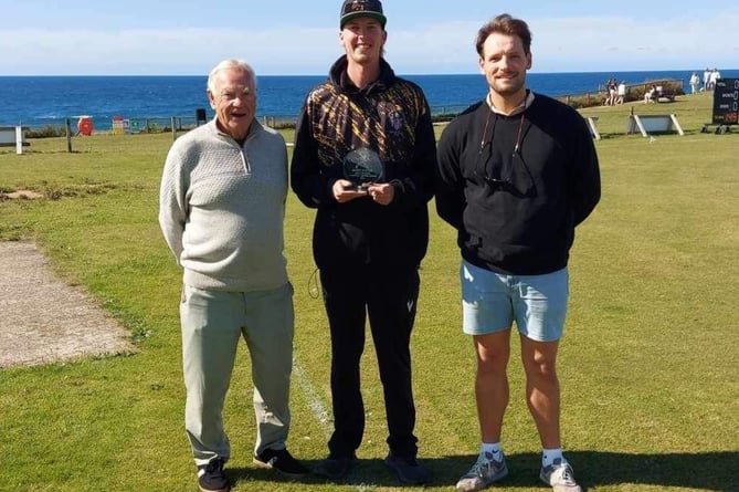 Brett Hunter (centre) was presented with a trophy by the club for superb haul of 62 wickets in 2024, the joint most in the county along with Grampound Road's pro, Ravi Karunarathna. He is pictured with chairman Tony Greaves and first team captain Warren Rumble. Picture: Bude CC