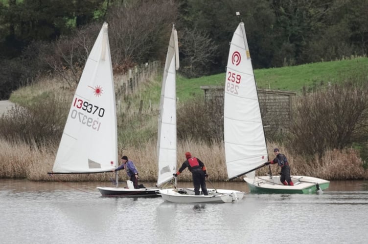 Bob Sampson, Dave Perrett and Nathan Pollard push out their booms to catch any breath of wind there might be. Picture: Mandy Pollard