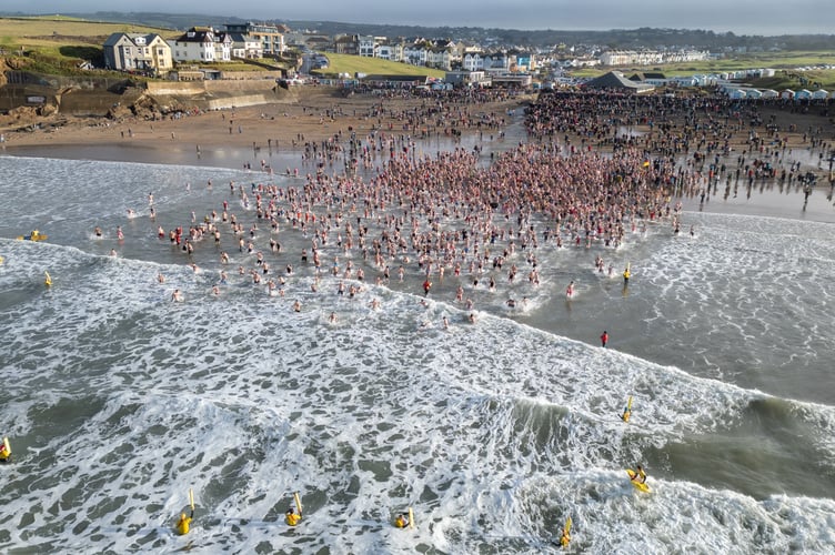 Bude Christmas Day Swim 2024. Swimmers gather for the annual Christmas Day dip at Crooklets Beach in Bude, Cornwall. Mark Theisinger 07976 918112