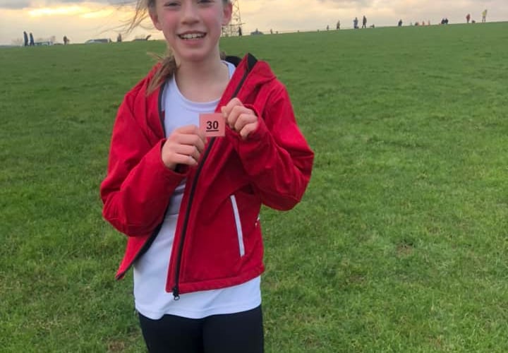 Chloe from Callington Primary is all smiles after completing her race