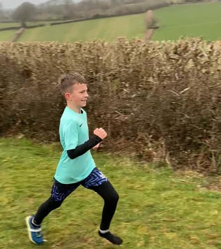 Edward from Carbeile School running minus a shoe after he lost it mid-race 